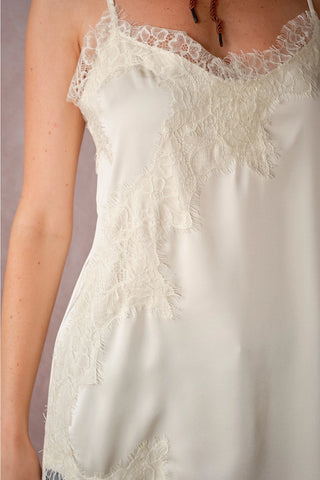 Ivory satin cami with asymmetrical lace trim detailing and thin straps