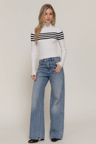 White ribbed turtleneck sweater top with black chest stripes, long sleeves