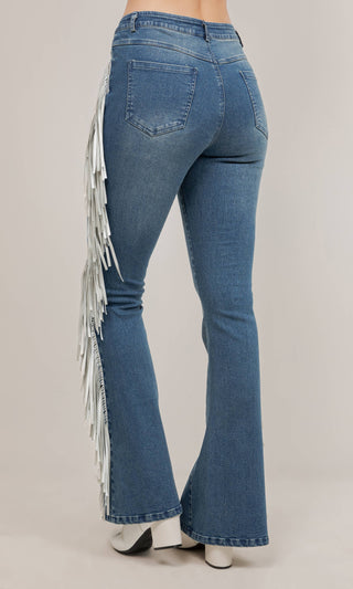 Medium wash flare jeans with white side fringe detail, back view