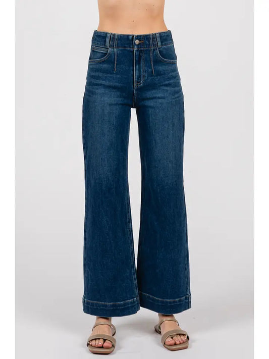 Blue jeans worn by a person on a white background
