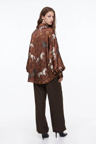 Brown oversized silky shirt with equestrian horse print and puff sleeves, back view