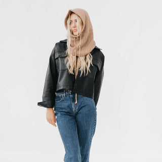 Tan knit balaclava hood worn over blonde model in black leather jacket