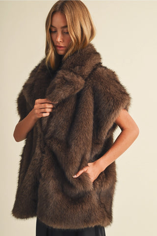 Cappuccino brown faux fur sleeveless vest with wide lapels and front pockets