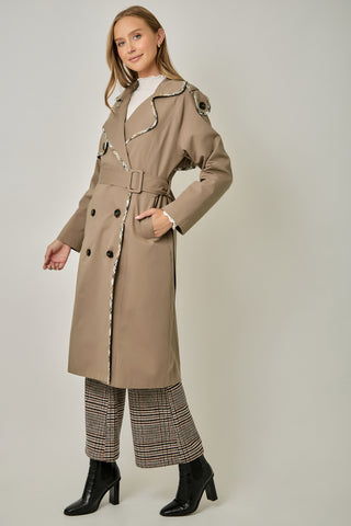 Taupe double-breasted midi trench coat with plaid trim, belt, and black buttons