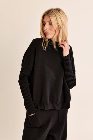 Women's oversized black knit sweater with ribbed cuffs and hem, crew neck