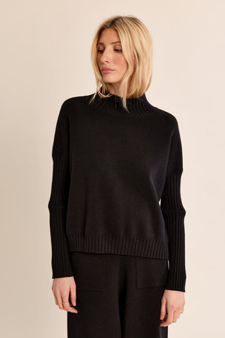 Black knitted mock-neck sweater with ribbed cuffs, hem, and relaxed fit