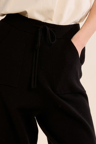Black knitted pants with drawstring waistband and side pocket detail