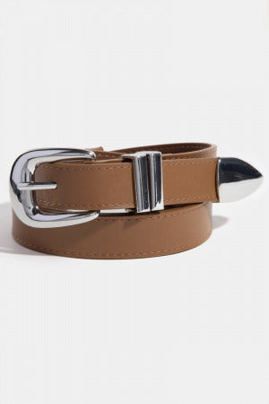 A tan leather belt with a polished silver-tone metal buckle and a matching pointed silver-tone tip, coiled on a light gray background.