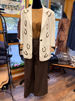Ivory blazer with gold horseshoe appliques, styled over tan top and brown wide-leg pants