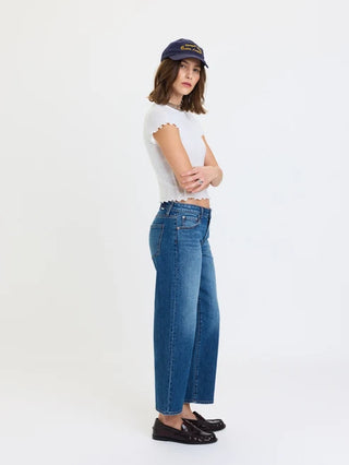 Women's low rise cropped straight jeans in medium blue wash, paired with white crop top