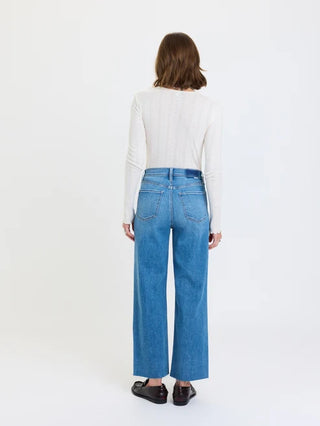 Back view of high rise wide ankle blue jeans in medium wash