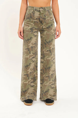 Camouflage pants worn by a person on a white background
