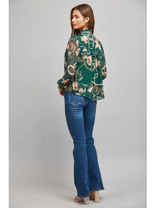 Green floral and chain print chiffon blouse styled with jeans and heels, full-length back view