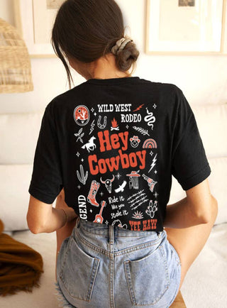 Person wearing a black t-shirt with 'Hey Cowboy' text and graphics.