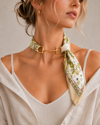 Ivory floral silk scarf necklace with gold equestrian horse bit hardware at neckline