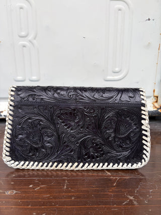 Black tooled leather clutch bag with white whipstitch border, floral pattern
