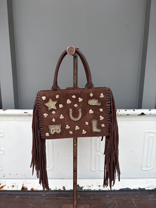 Brown suede fringe tote bag with gold western charm appliques and leather handles
