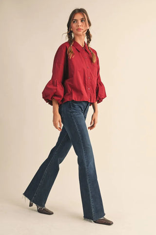 Burgundy button-down top with voluminous bubble sleeves and point collar