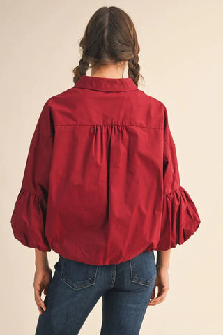 Burgundy bubble sleeve button-up top with gathered back detail and collar