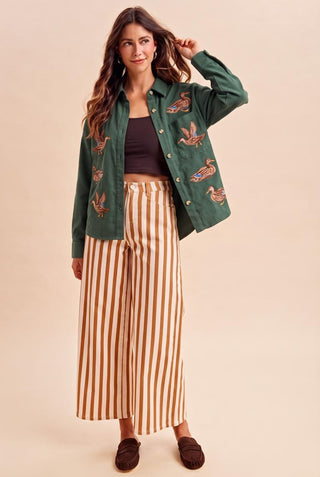 Annie Wear Mallard green duck-embroidered button-up shacket worn open over striped wide-leg pants