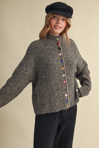 Black and taupe knit cardigan with multicolored buttons and mock neck