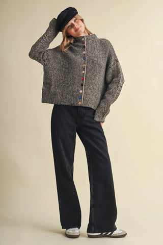 Black and taupe knit cardigan with multicolored buttons and mock neck