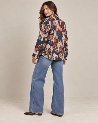 Navy red abstract tapestry jacket with wide-leg jeans, back view