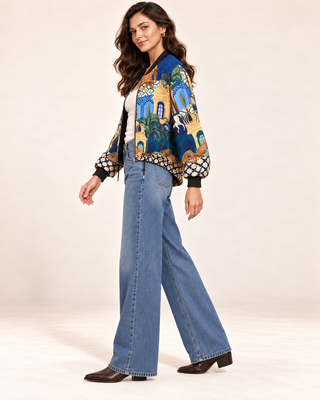 Flora Ashley silk blend bomber jacket with blue palace print, worn with wide-leg jeans