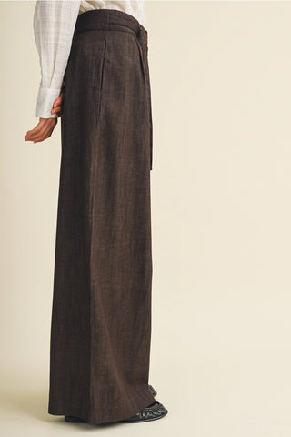 Wide leg espresso brown linen pants with buckle pleat waist detail, side view