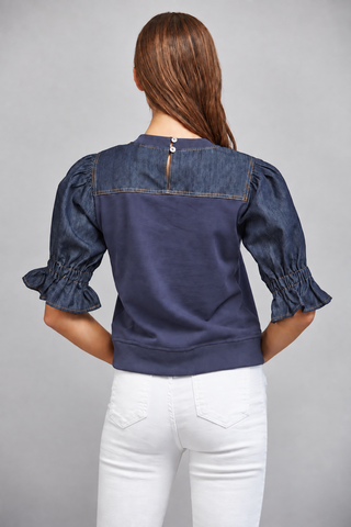 Dark navy sweatshirt with denim puff sleeves, ruffle cuffs, and keyhole back