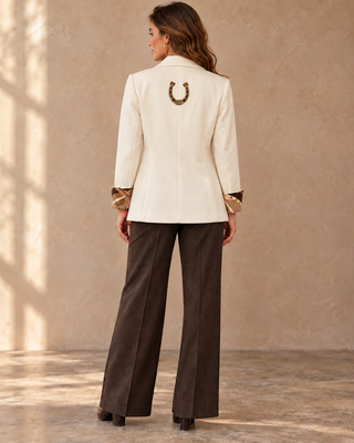 Ivory blazer with gold horseshoe applique on back and patterned cuffs