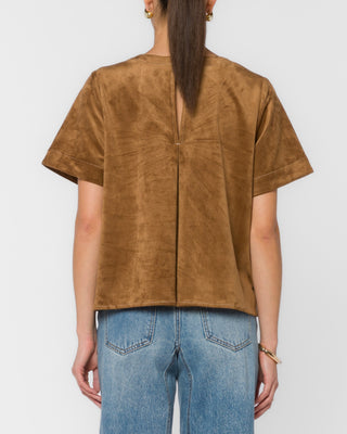 Back view of light tan suede short-sleeve top with center seam detail
