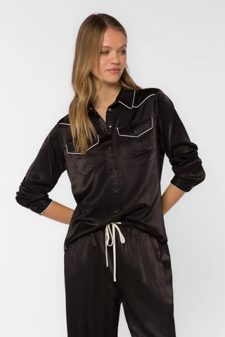 Black satin western shirt with cream piping, snap buttons, and chest pockets