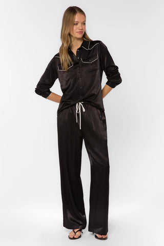 Black satin western shirt with white piping, chest pockets, and snap buttons