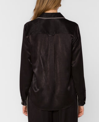 Black satin long-sleeve shirt with white piping trim, back view