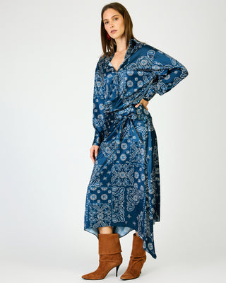 Navy blue paisley bandana print midi skirt with asymmetric hem, worn with brown boots