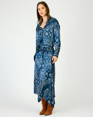 Navy blue paisley print maxi skirt with asymmetric hem, worn with brown boots