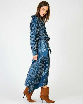 Navy blue paisley print satin midi skirt with tie waist, styled with brown heeled boots.