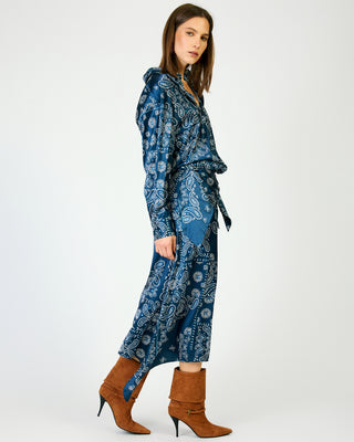 Navy blue paisley print midi skirt with satin finish, worn with brown heeled boots