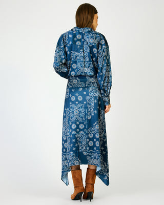 Navy blue paisley bandana print midi skirt with asymmetric hem, worn with brown boots