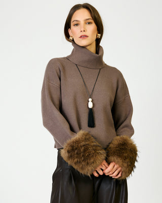 Mocha turtleneck ribbed knit sweater with faux fur cuffs and tassel necklace