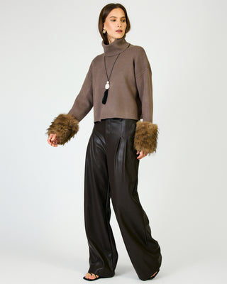 Mocha turtleneck cropped sweater with brown faux fur cuffs on female model