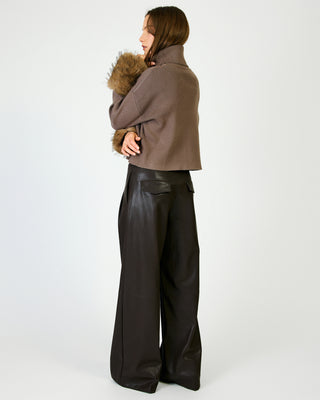 Cropped mocha ribbed turtleneck sweater with faux fur trim, styled with wide-leg black pants.
