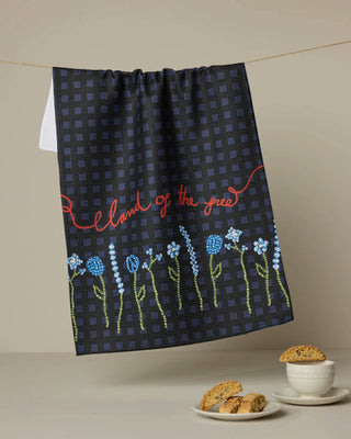 Decorative towel with floral design and text on a beige background
