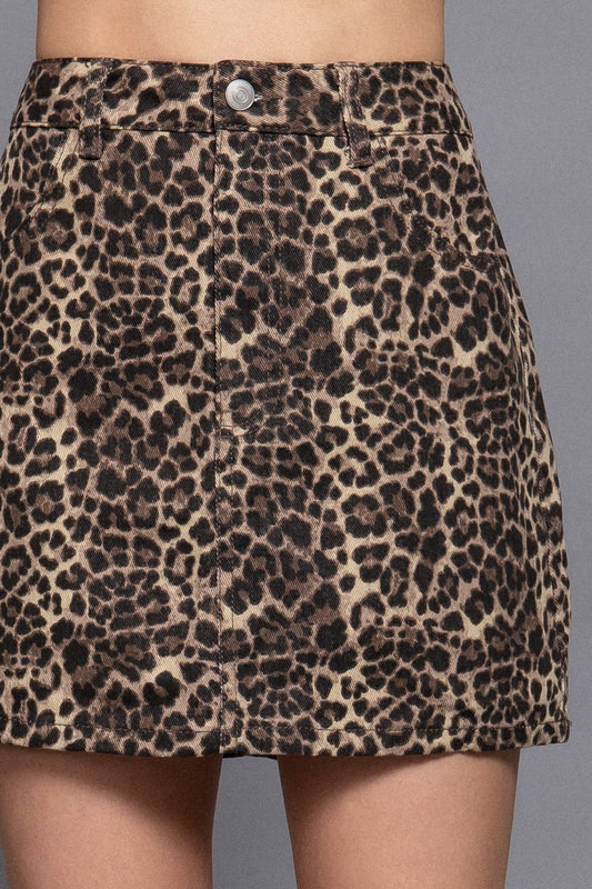 Leopard print skirt worn by a person on a gray background