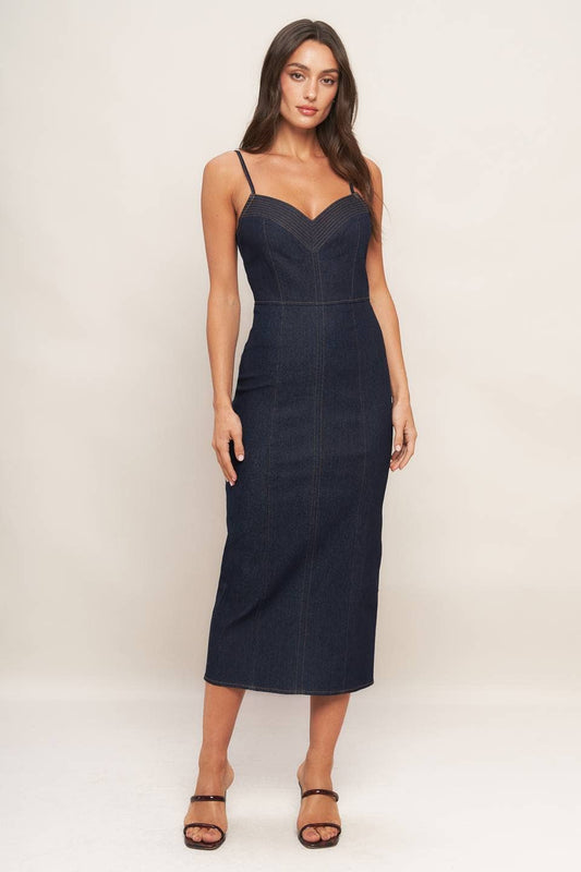 Woman wearing a navy blue dress against a white background
