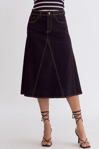 Black denim skirt worn by a person on a white background