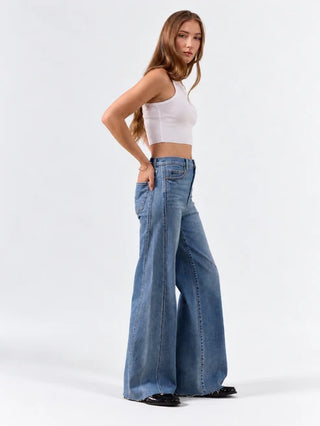 High rise wide leg blue jeans with seaming detail, worn with white crop top