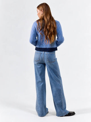 Light wash high rise wide leg jeans shown from the back on a female model