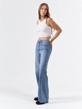 High rise wide leg blue jeans with seaming detail, paired with white crop top